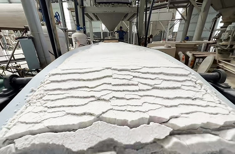 How is the iron in quartz silica sand removed?